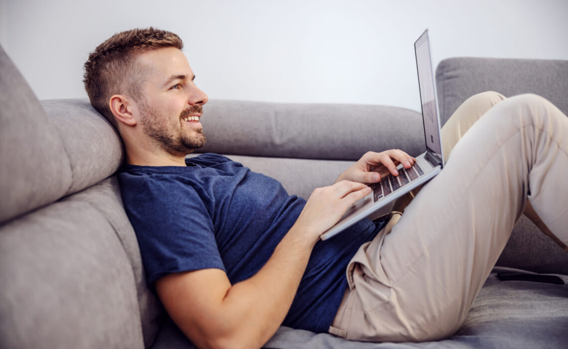 Man on sofa using laptop