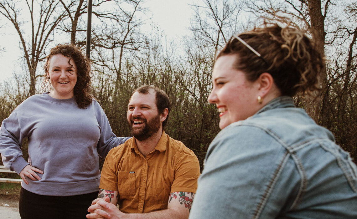 group of people outdoors chatting to each other sitting down