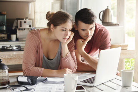 Young Man And Woman looking at a laptop together
