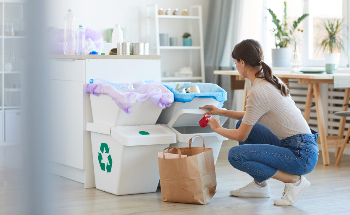 Menyw yn didoli sbwriel yn y gegin