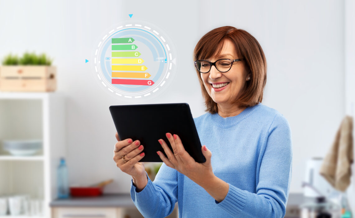 Senior Woman Using Tablet Pc With Energy Chart